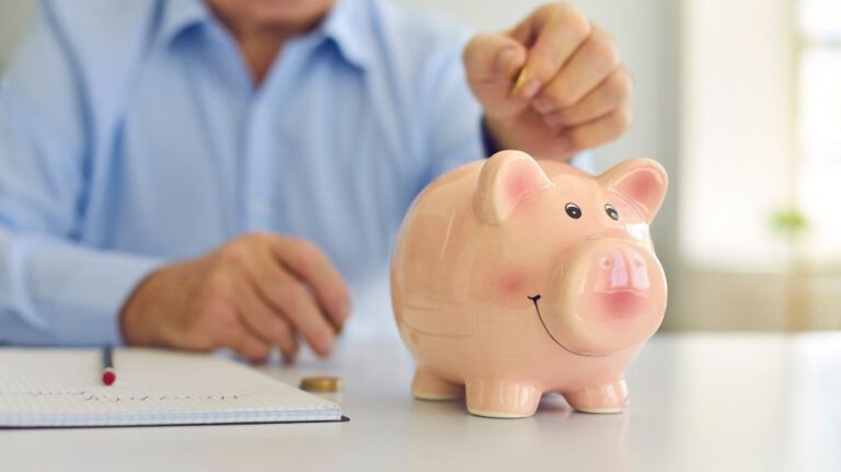 Man Putting Coins in a Piggy Bank