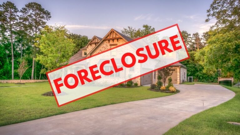 Home with White and Red Foreclosure Banner Over the Top