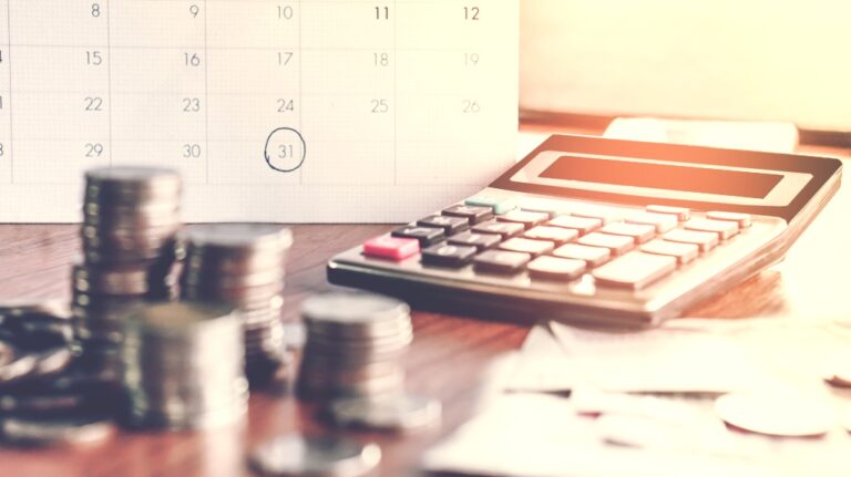Calculator next to money and calendar